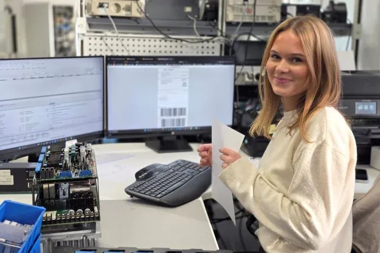 Schirmer GmbH employee at her workstation with CNC control boards